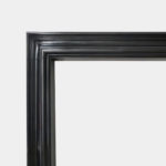 A Black Marble Bolection Fireplace